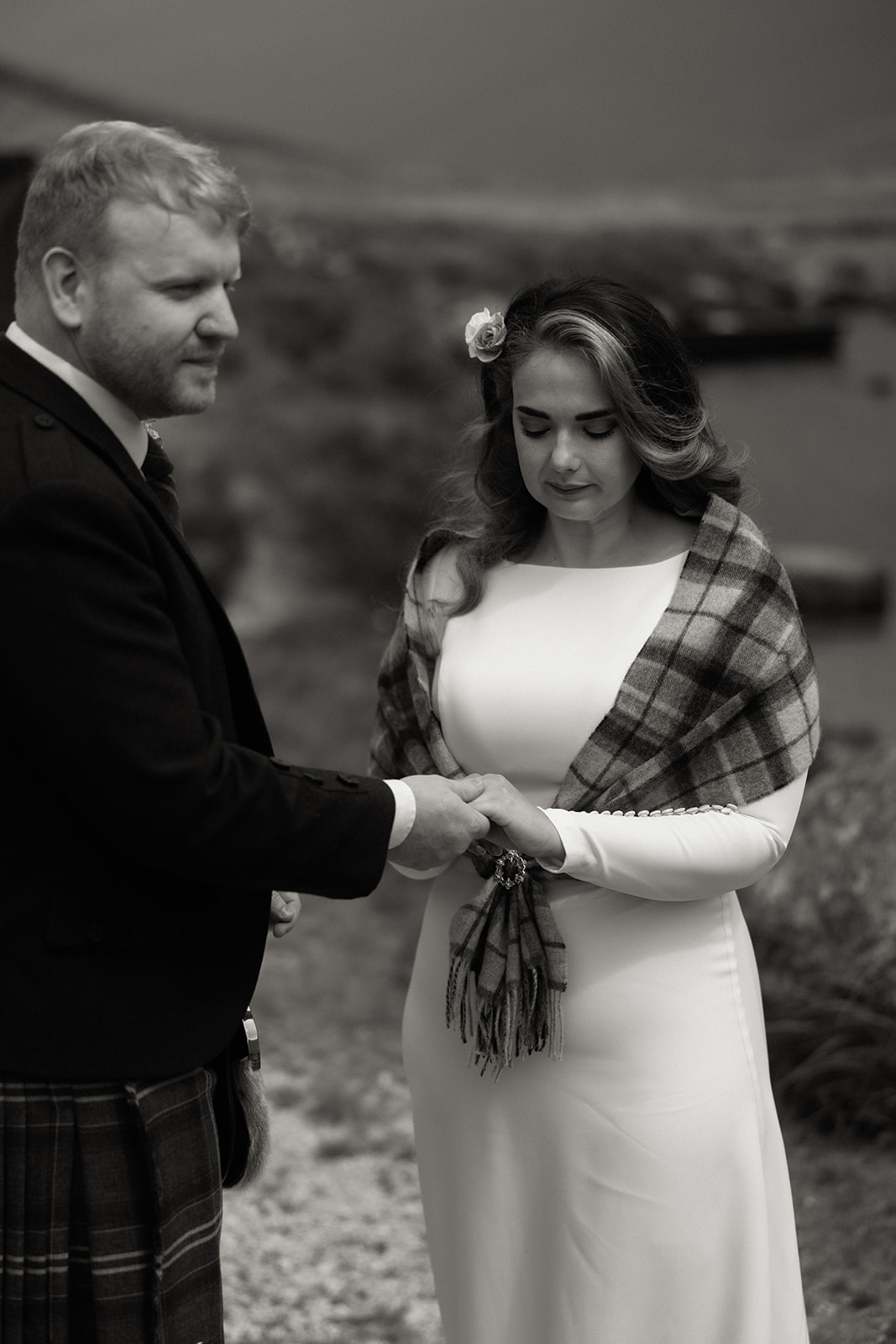 Black and white photograph of bride and groom with celebrant during outdoor elopement on the Isle of Arran.
