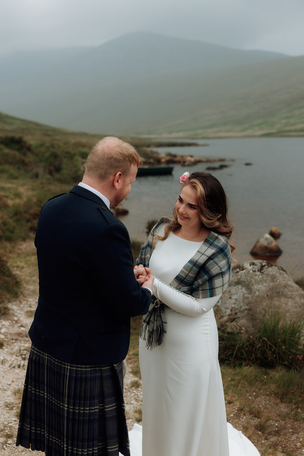 Bride and groom facing each other during elopement ceremony by Loch Iorsa, Isle of Arran.
