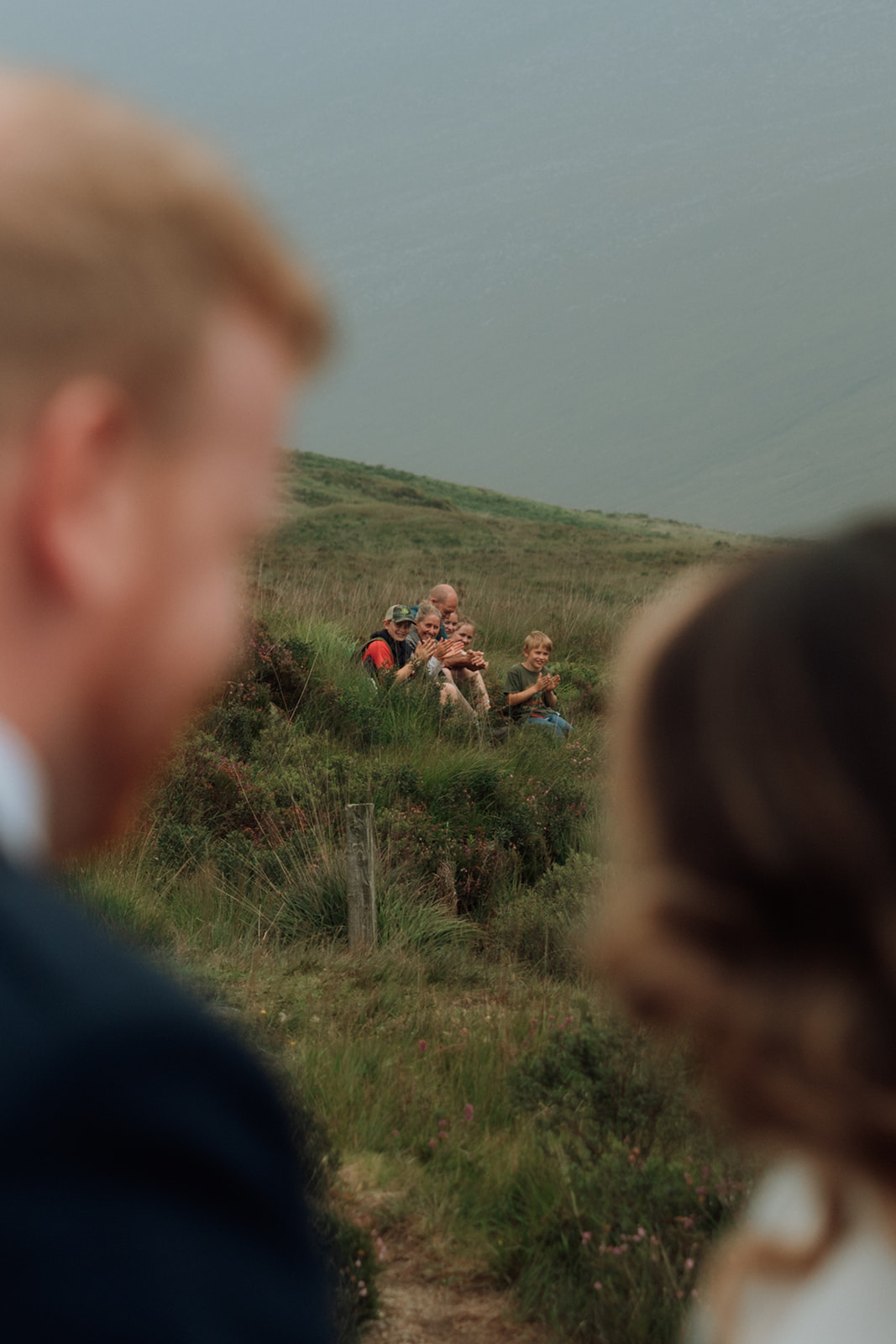 A family hiking past paused to watch Sophia and Chris’s ceremony, becoming unexpected guests at their Isle of Arran elopement.