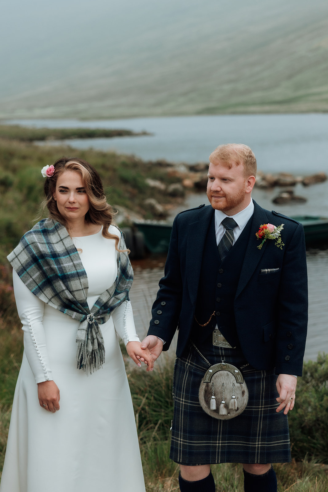 Bride and groom holding hands after their Isle of Arran elopement ceremony.