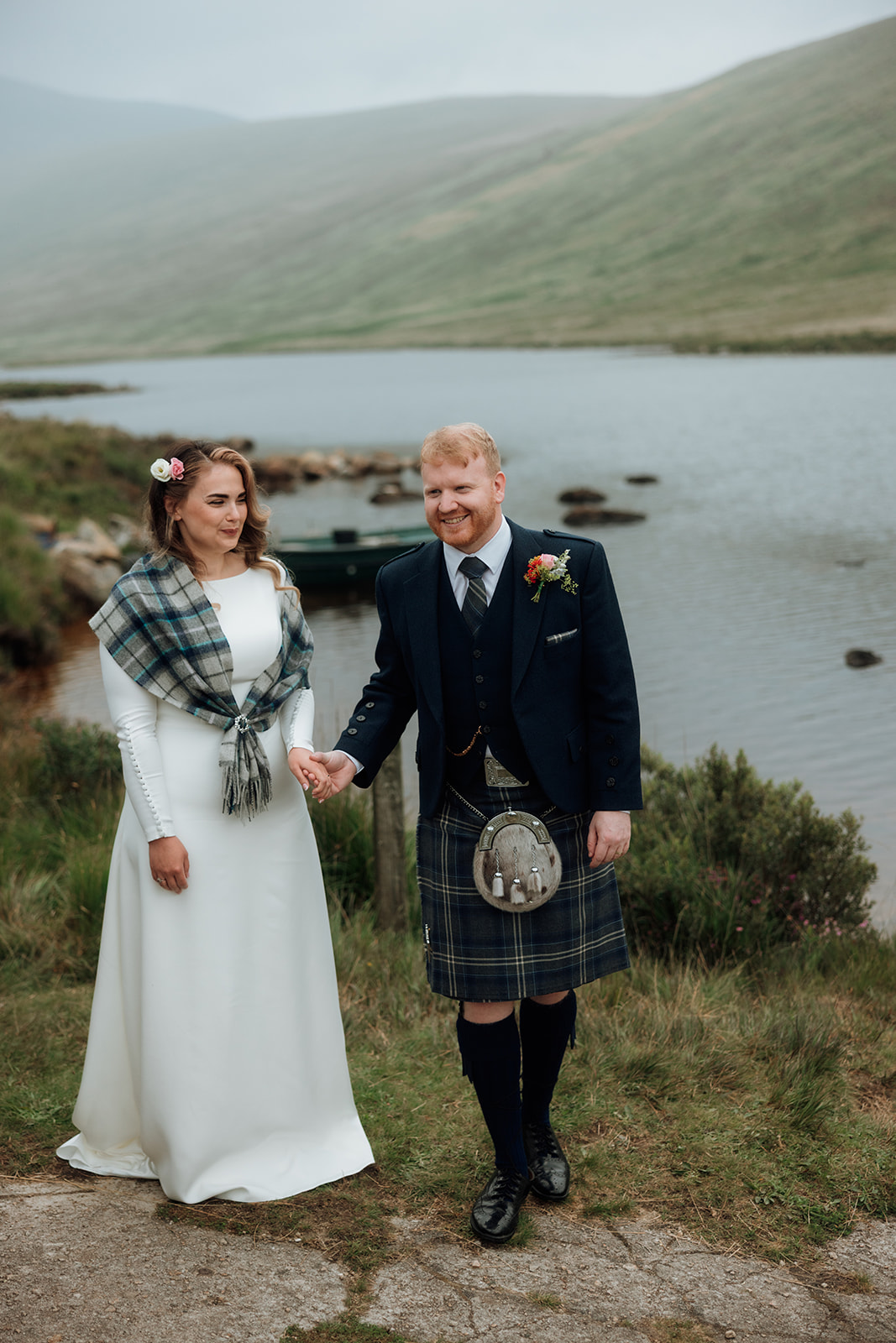 Bride and groom standing by Loch Iorsa after their elopement on the Isle of Arran.