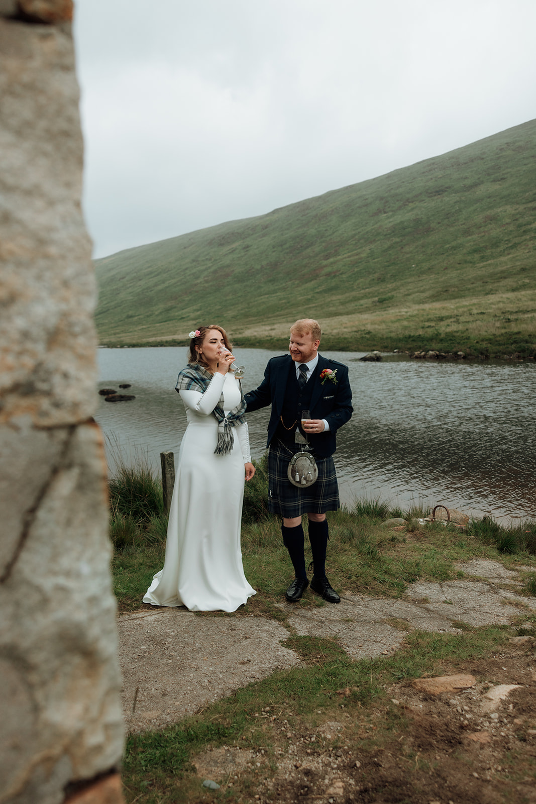 Bride and groom standing side by side by Loch Iorsa during elopement.