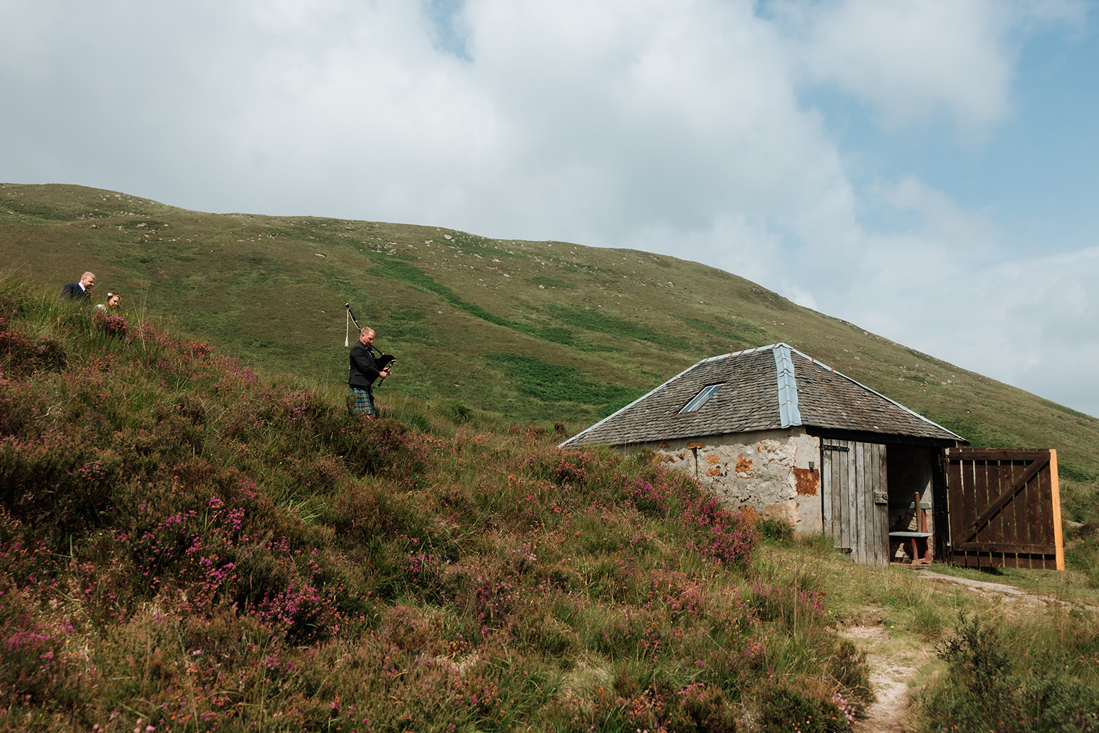Bride and groom walking toward the Dougarie Boathouse on the Isle of Arran.
