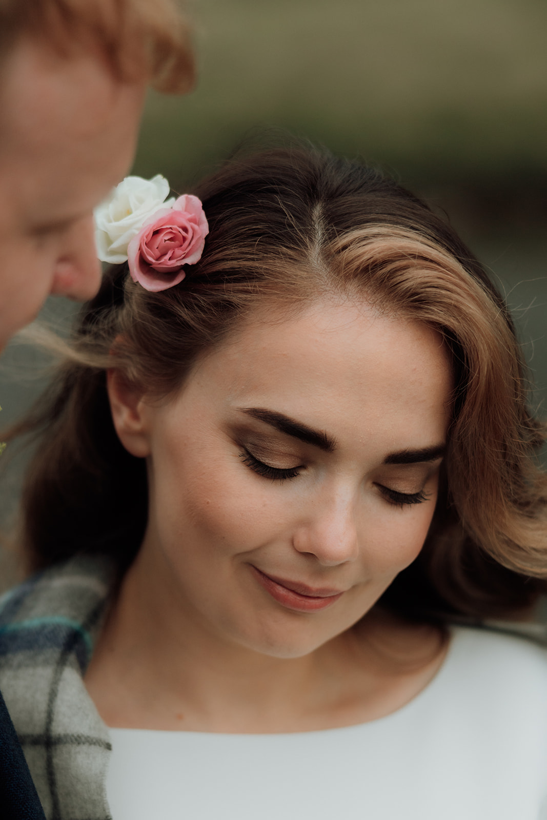 Close-up portrait of bride with flowers in her hair during Isle of Arran elopement.