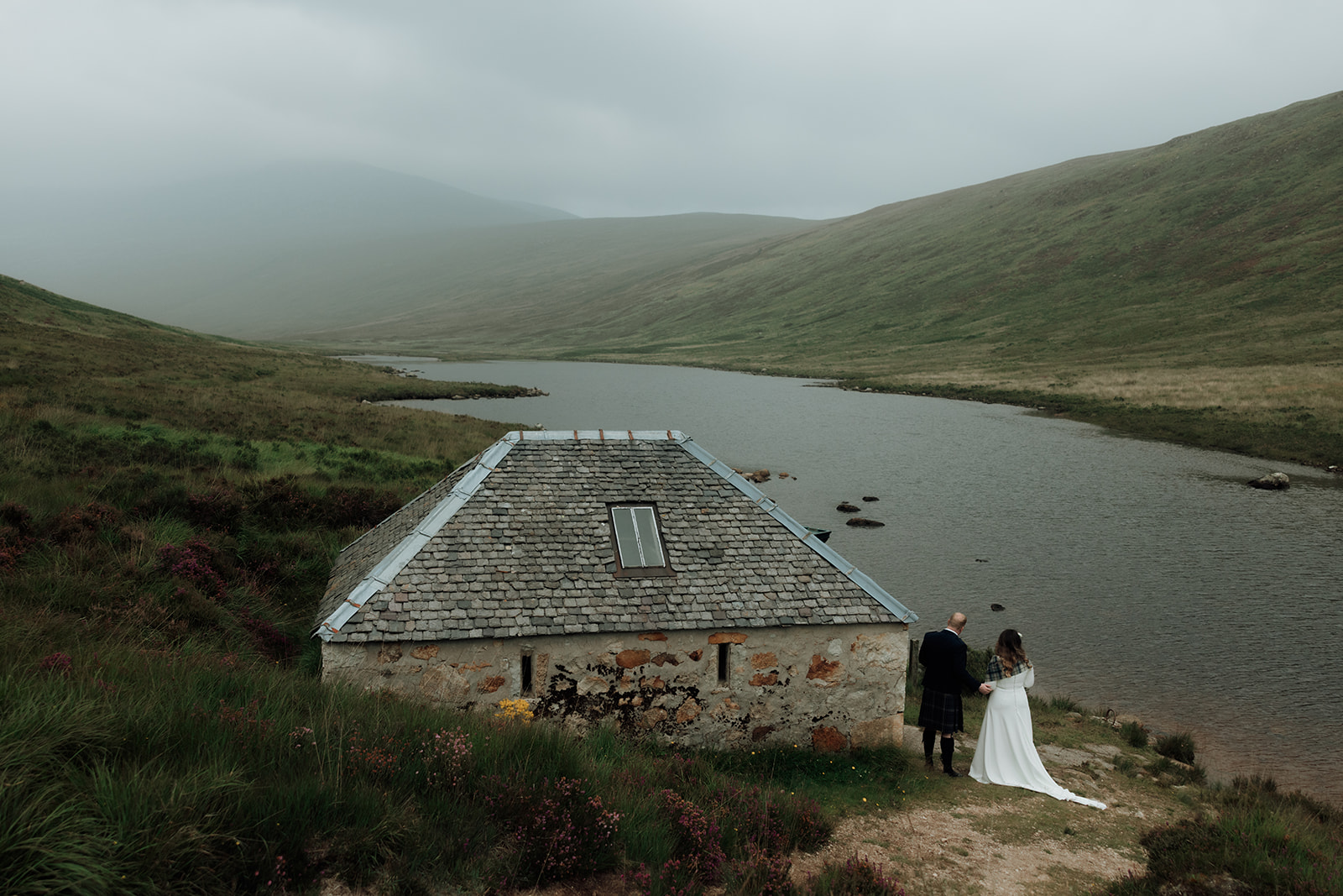 Stone Dougarie Boathouse with loch and hills in background, Isle of Arran.