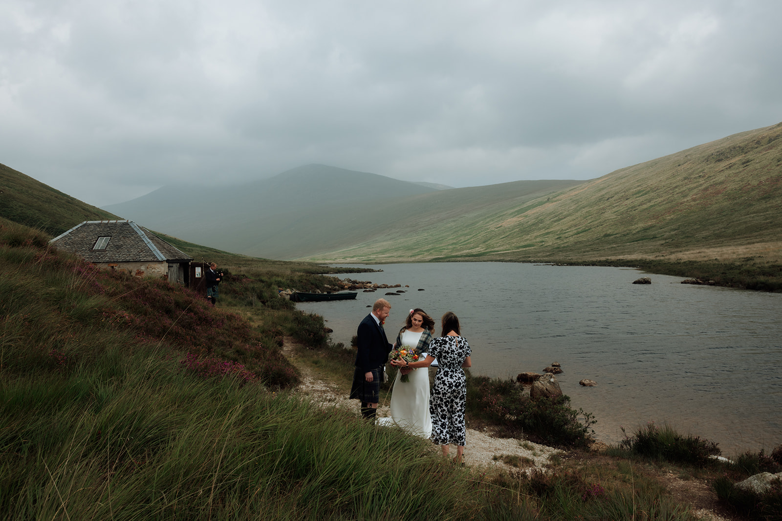 Bride and groom with their celebrant at an outdoor elopement ceremony by Loch Iorsa, Isle of Arran.