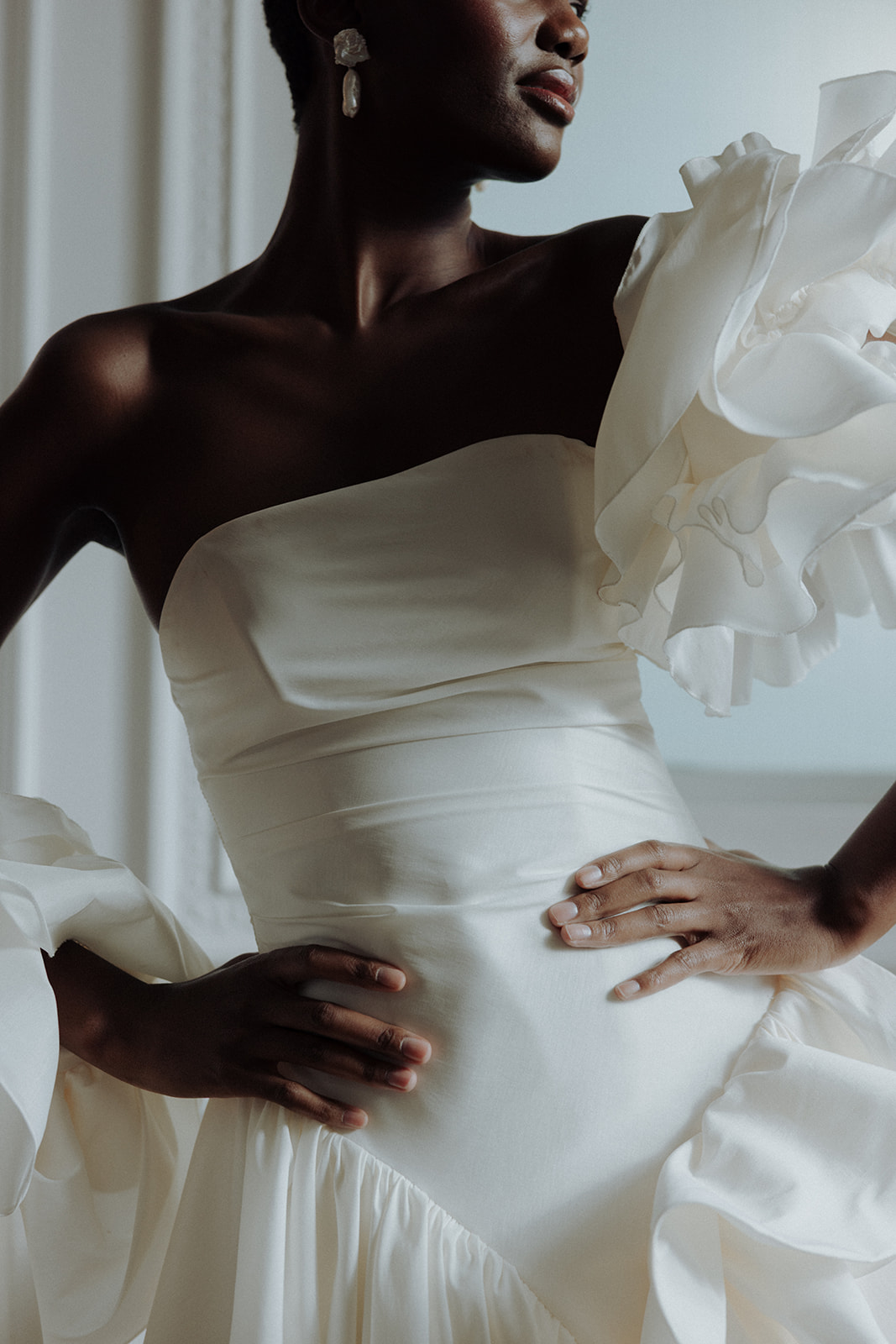 Shadows and sculptural fabric create cinematic bridal imagery.