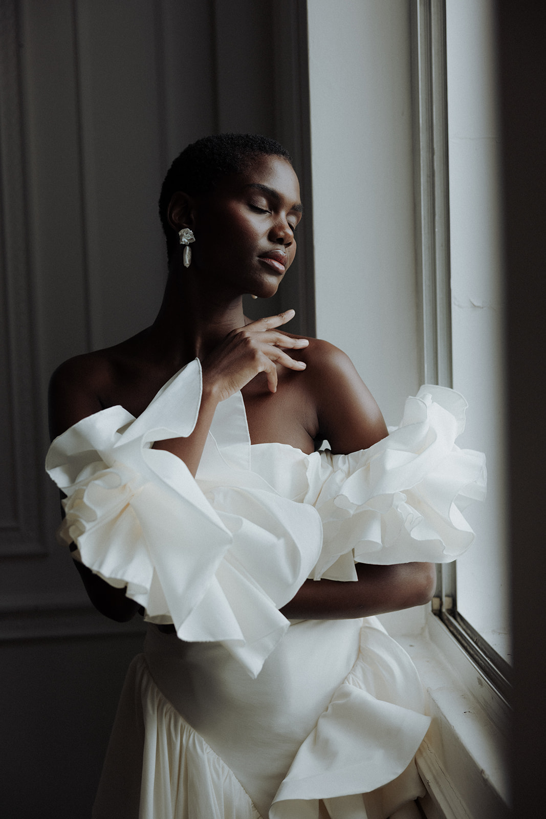 Sculptural ruffled sleeve detail of Darla Haute Couture bridal gown, editorial fashion photograph.
