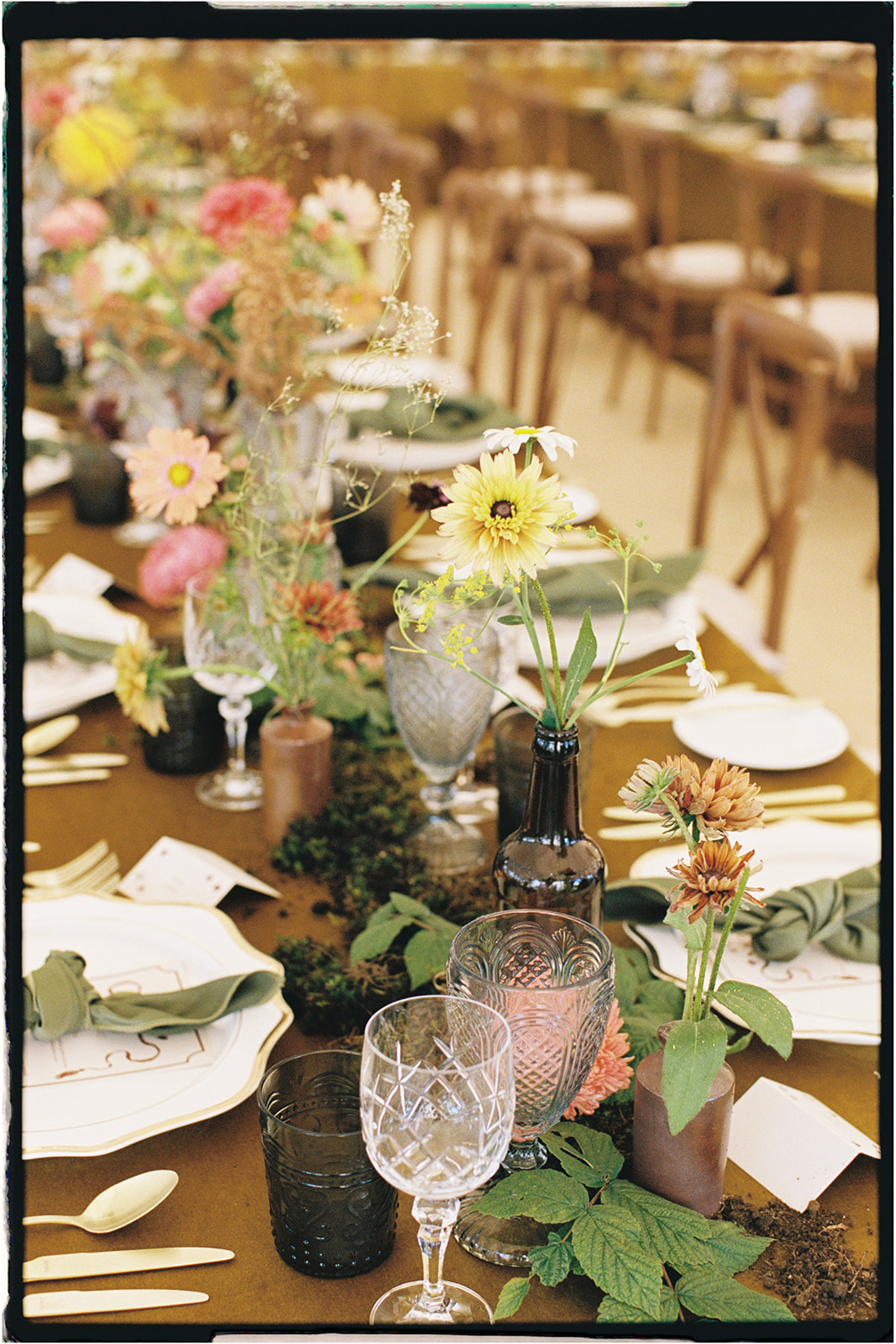 Editorial wedding tablescape styled by Tupelo Tree with golden linen, textured florals, and natural foliage, photographed on 35mm film.